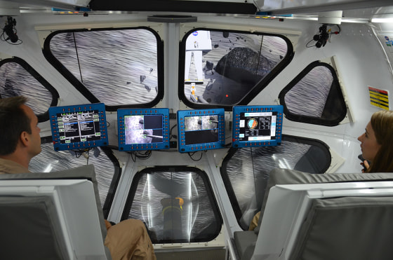 Scientist Liz Rampe and flight controller David Coan pilot NASA’s multi-mission Space Exploration Vehicle (SEV) during an asteroid mission simulation at the Johnson Space Center in Houston on Thursday.