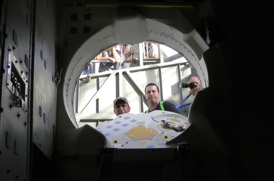 Patch-eye view: NASA techs look into space shuttle Endeavour's crew cabin after storing patches and a photo on board for the orbiter’s final ferry flight.