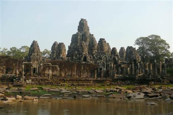 Bayon temple, constructed by Angkorian King Jayavarman VII in the late 12th century. The complex was built to honor the Hindu god Vishnu, but 14th-century leaders converted the site into a Buddhist temple.