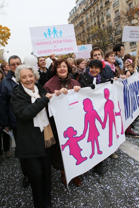 Image: A protestor holds a banner during a demonstration denouncing same-sex marriage