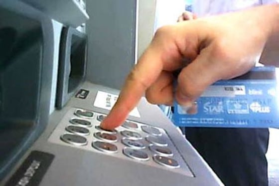 A still shot of the hidden camera's video feed, clearly showing a customer typing in his card PIN.