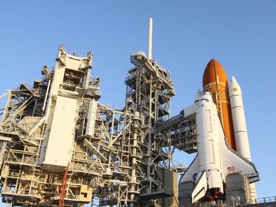 Crews move the primary payload for space shuttle Endeavour's STS-134 mission into the Payload Changeout Room on Launch Pad 39A at NASA's Kennedy Space Center in Florida.