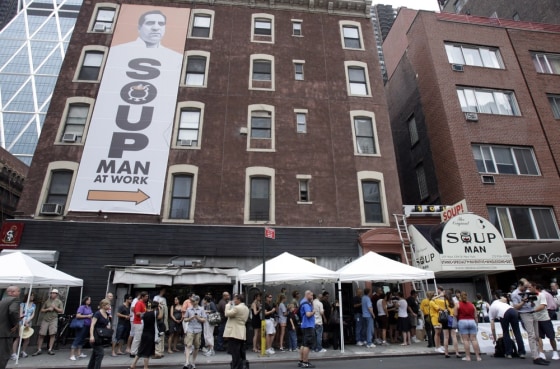 Image: People stand in line outside the The Original SoupMan location