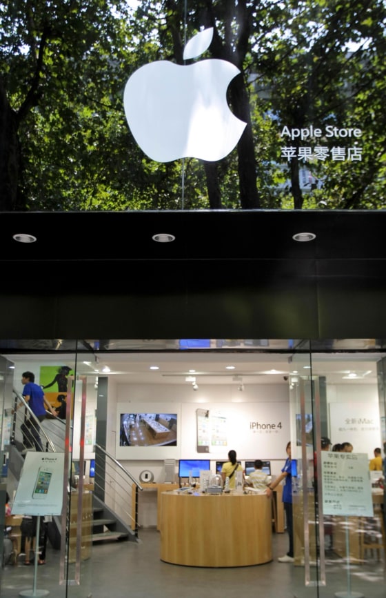 Image: Customers and employees are seen in a fake Apple store in Kunming