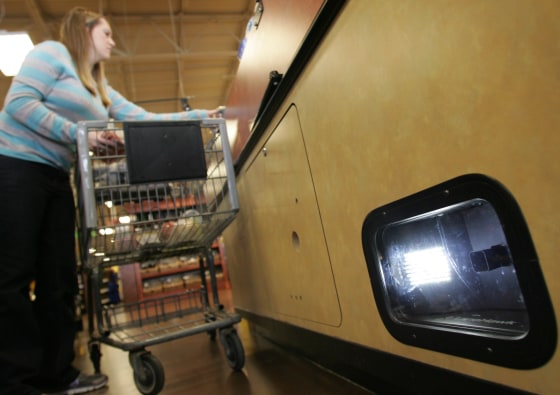 Image: Brooke Zupnick unloads her grocery cart near the LaneHawk loss prevention device at a Kroger store in Gahanna, Ohio