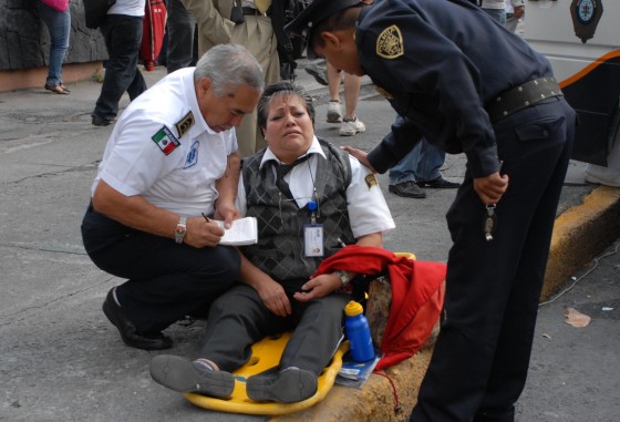 Image: Police assist a subway staff after a mass shooting at the subway