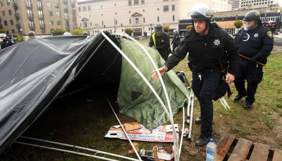 Image: Police officers clear an Occupy Oakland camp