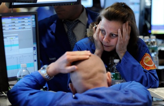 Image: Specialists work at a post on the floor of the New York Stock Exchange