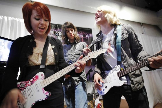 Image: Carly Kalafus, left, Ben Spremulli, center, and Duran Visek perform on Paper Jamz guitars