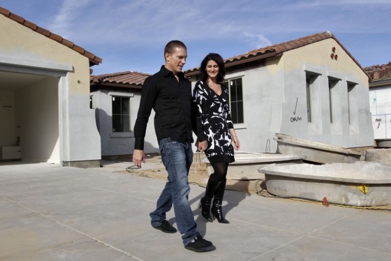 Image: Katie and Mike Zwanziger leave their new home after checking on its progress in Gilbert, Ariz.