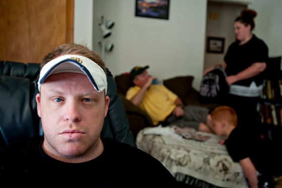 Doug Wallace Jr., 33, at his father's home in Plain City, Ohio, with his father, Doug, his younger sister, Megan, and his nephew Scott.