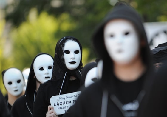 Protesters carry signs with the names of the dead from America's wars on Monday. While the anniversary of the war in Afghanistan was the main focus of the demonstration, some protesters also remembered those who have died in Iraq.