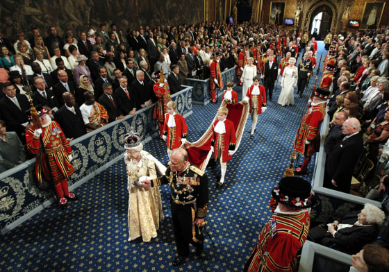 Image: Britain's Queen Elizabeth and Prince Philip walk through the Royal Gallery in the Palace of Westminster