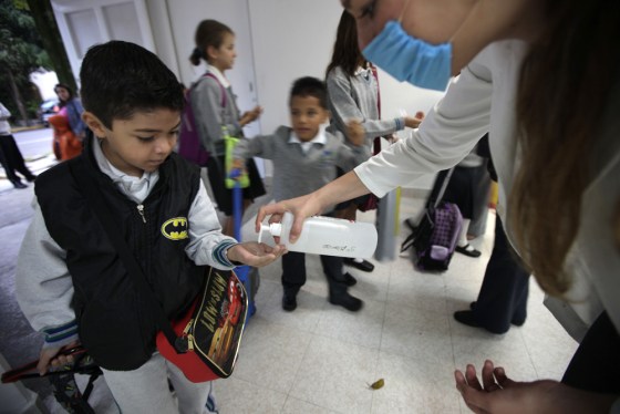 Image: school official hands out antibacterial gel
