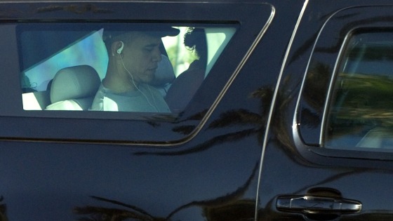 Image: US President Barack Obama rides in an SU