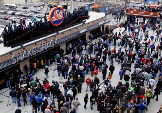 People wait in line at the Shake Shack at Citi Field before the New York Mets and Boston Red Sox exhibition baseball game in New York earlier this month.