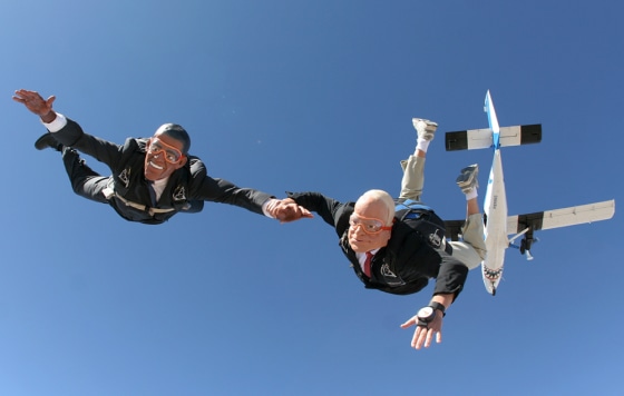 Image: Parachutists dressed as presidential candidates jump from a plane