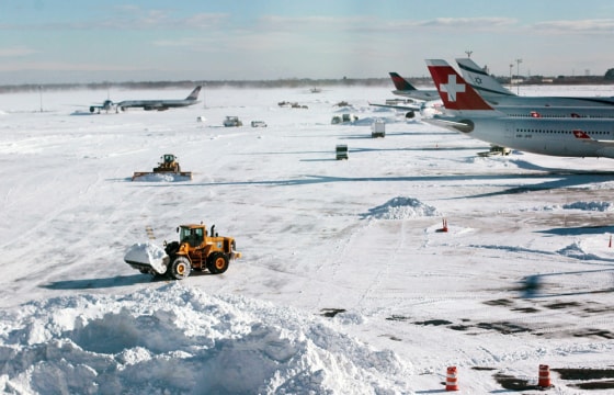 Image: Heavy equipment clears snow from the tarmac around Terminal 4 following a major blizzard at John F. Kennedy International Airport