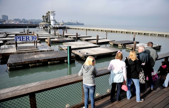Image: Tourists look at Pier 39 where sea lions used to abound.