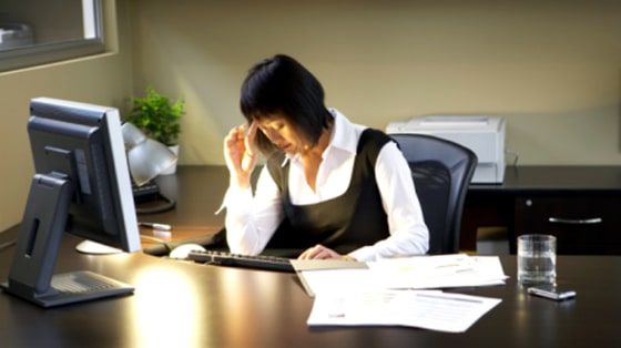 Image: Woman sitting at a desk