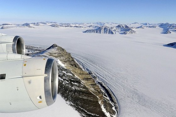 A NASA research aircraft flies over Alexander Island and a connected plain of ice, the George VI ice shelf, where the moving lakes were found.