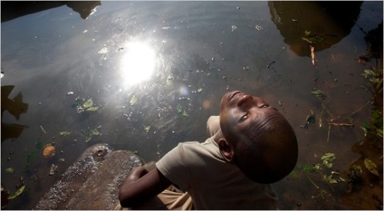 A boy playing by Bodo Creek in Bodo, Nigeria. As many as 546 million gallons of oil spilled into the Niger Delta over the last five decades, experts said.