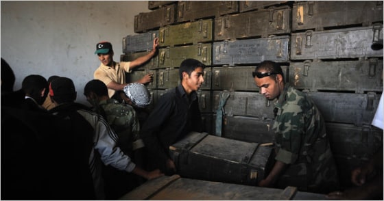 Rebel soldiers swarmed a military compound in western Libya on Tuesday after driving out its garrison of about 100 soldiers. The rebels found plenty of ammunition, but no rifles.