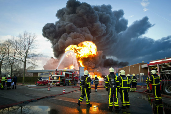 Image: Firemen try to extinguish a fire on the