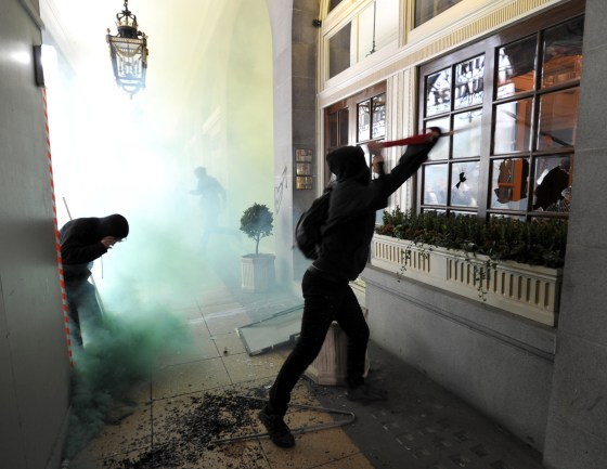 Image: Demonstrators break windows of the Ritz Hotel, during a protest organised by the Trades Union Congress in central London