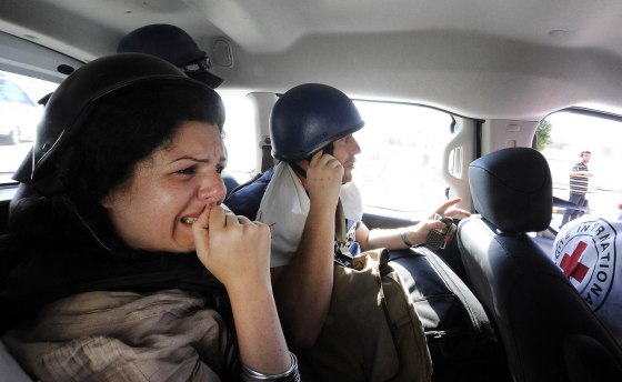 Image: Jomana Karadsheh and Matthew Chance from CNN are evacuated by the International Red Cross from the Rixos hotel in Tripoli