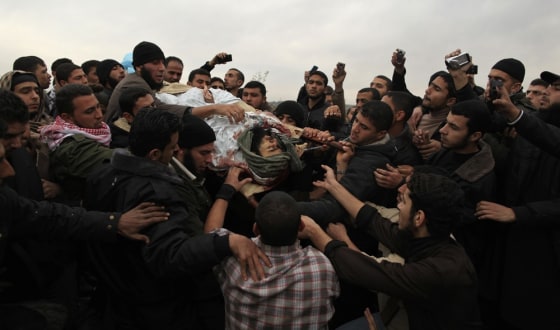 Image: Palestinians carry the body of militant Abu Daf during his funeral in Gaza