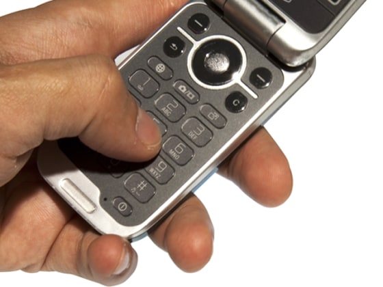 Image: Hand dialing a phone