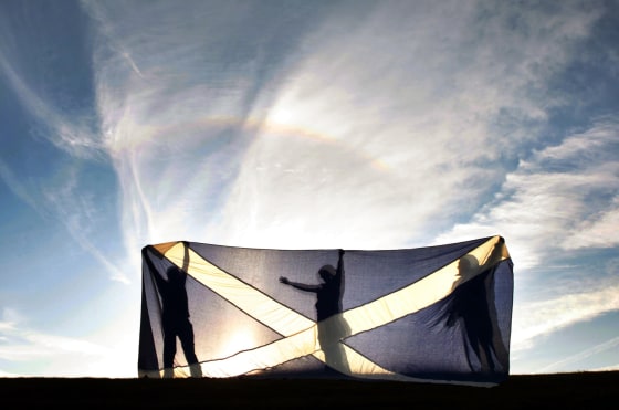 The flag of Scotland, the Saltire, is held aloft in Glenrothes during a by-election campaign.