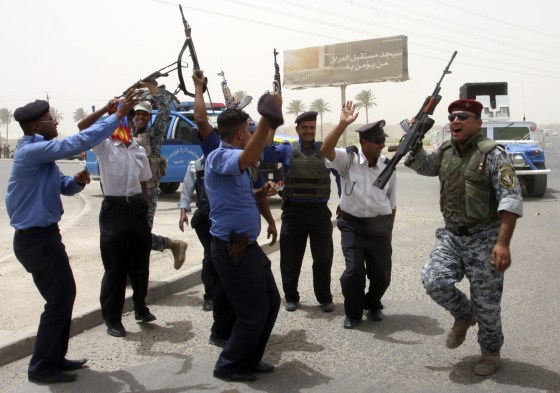 Image: Iraqi security forces celebrate during the withdrawal of U.S. troops in Baghdad