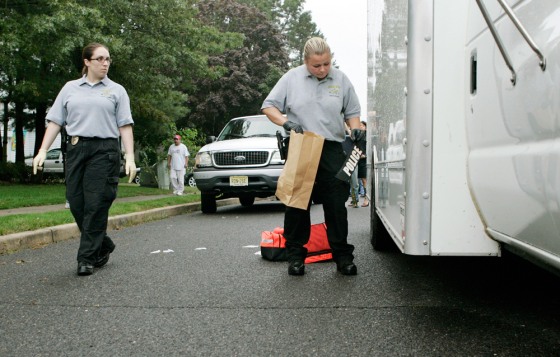 Image: Police gather evidence where officers were shot.