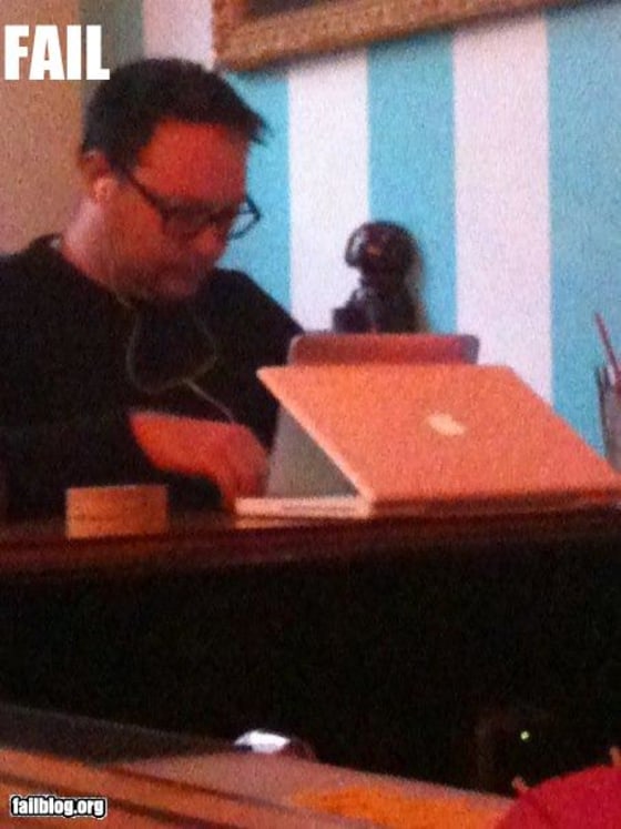 The iPad has some design and functionality issues, as became clear when I used my iPhone to take this picture of someone using his iBook to prop up his iPad.