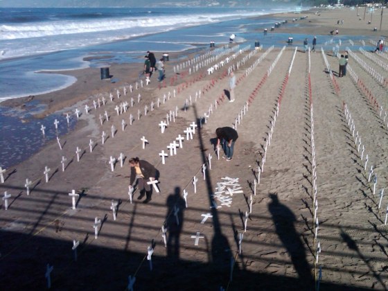 Volunteers tend to memorial crosses in Santa Monica, Calif.