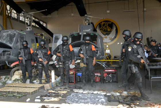 Guatemalan anti-narcotics police on March 27 show weapons confiscated from what they said was a training camp run by Mexico's Los Zetas drug cartel. The group was one of three placed Wednesday on a U.S. list of international drug traffickers.