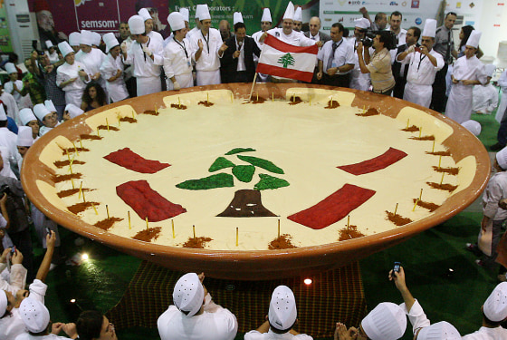 Lebanese chefs celebrate around their hummus creation in Beirut on Saturday. The tree and red bars are taken from the design of Lebanon's flag.