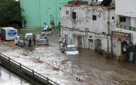 People are stranded in a flooded area in the Saudi Red Sea city of Jiddah on Wednesday.