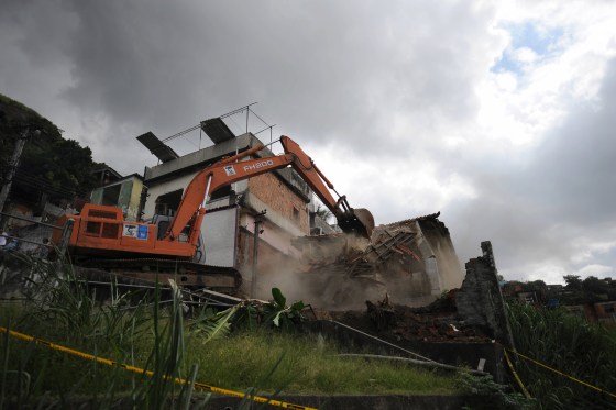 Municipal workers knock down homes in the Morro do Urubu shantytown outside of Rio de Janeiro, Brazil, on Monday. The homes are among the thousands considered at risk due to unstable hillsides.