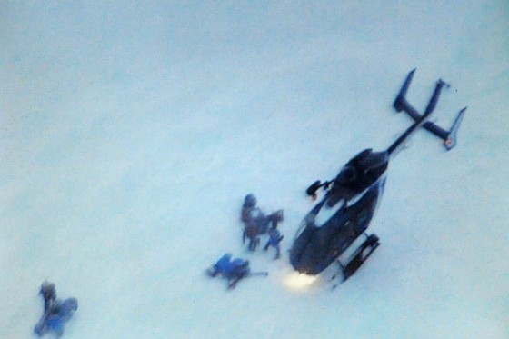 Rescuers land at the site of an avalanche that killed four people Wednesday in the French Alps at Valmeinier.
