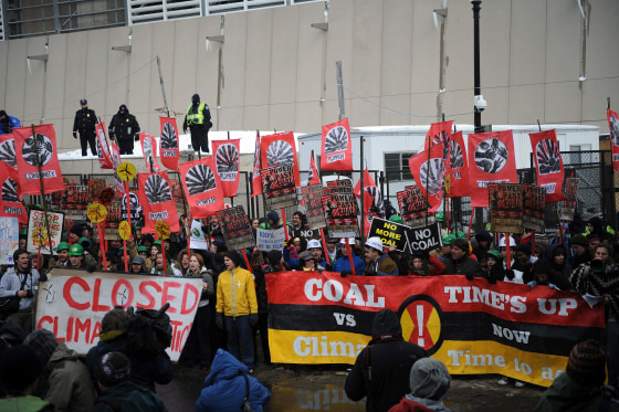 Protesters on Monday stand in front of the US Capitol Power Plant to demand that it switch from coal to natural gas power.