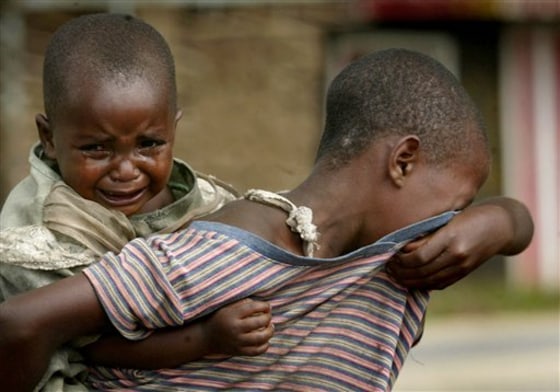 This photo of an 11-year-old girl carrying her 3-year-old niece as she looks for her parents in the village of Kiwanja, eastern Congo, drew reaction from people around the world wanting to help them.