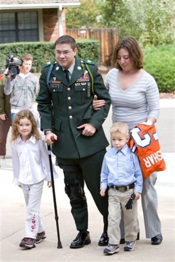 Ian Newland, who was severely wounded in Iraq, arrives at his home in Denver, in October 2007, with his wife Erin, daughter Haley, 6, and son Dryden, 4.