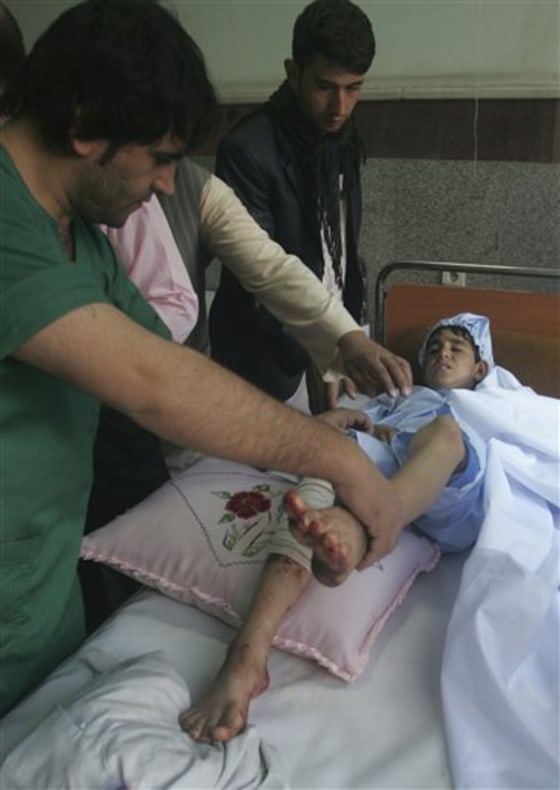 An Afghan doctor helps a boy after he has been injured in an explosion by a remote-controlled bomb killing a police woman and two civilians in Herat, Thursday, Sept. 29.