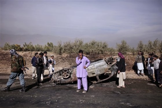 Afghans check a car which was destroyed following an explosion in a fuel tanker in Parwan province, north of Kabul, on Wednesday. 