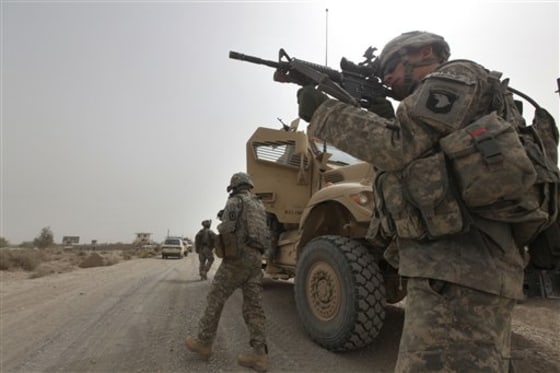 U.S. Army Spc. Cody Borawa, of Unadilla, N.Y., of Tactical Command Post, HQ Company, 2-502 Infantry, 101st Airborne Division, looks for a Taliban position, during a day of joint missions with the Afghan Army, in Zhari district, Kandahar province, southern Afghanistan, on Aug. 26. 