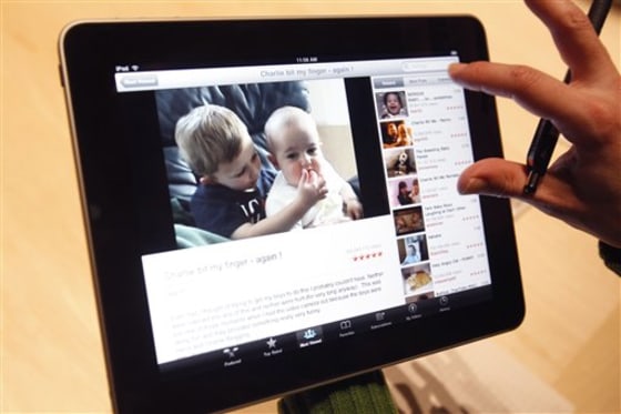 The Apple iPad tablet is examined after its unveiling Jan. 27 in San Francisco. Versions of the device will be available with Wi-Fi only, as well as with a 3G chip for use on AT&T's wireless network.