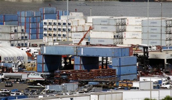 Shipping containers are off-loaded at the Port of Miami. The U.S. trade deficit surged in June to the highest level since October 2008 and imports of foreign consumer goods hit an all-time high.